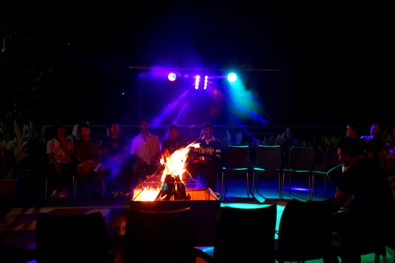 Guests gathered around the evening campfire on the resort terrace
